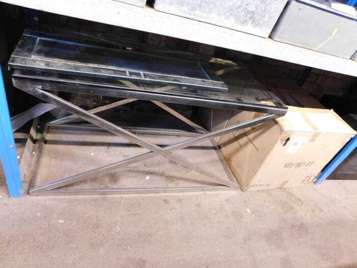 A steel and glass coffee table, the top glass with an X frame, together with two similar side...