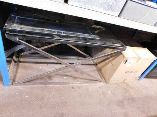 A steel and glass coffee table, the top glass with an X frame, together with two similar side...