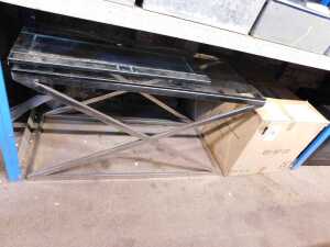 A steel and glass coffee table, the top glass with an X frame, together with two similar side...
