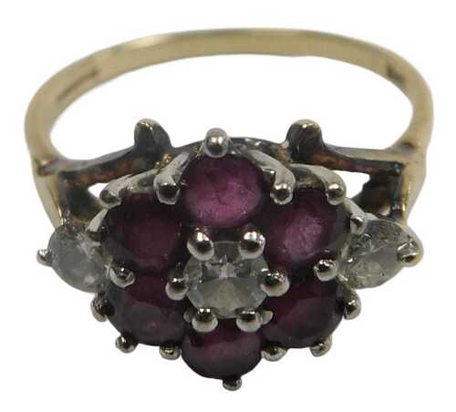 An 18ct gold ruby and diamond flower head ring, in a claw setting, size Q, 3.6g.