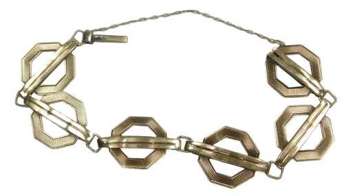 A hexagon and bar six link bracelet, on a snap clasp, with safety chain as fitted, yellow metal...