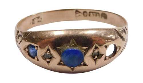 A 9ct gold and blue set three stone gypsy ring, one stone lacking, with diamond chips at...