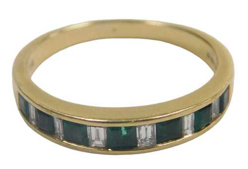 An 18ct gold emerald and diamond half hoop eternity ring, the emerald cut stones flanked by...