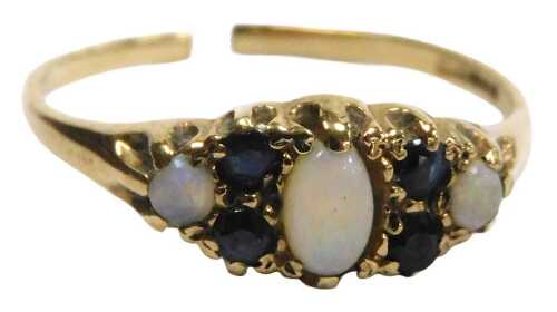 A 9ct gold and opal three stone ring, set with pairs of sapphires and intervals, cut, 1.3g.