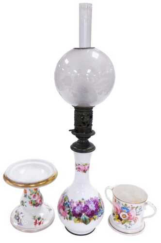 A Continental porcelain and brass oil lamp, painted with flowers, with a chimney and an etched...