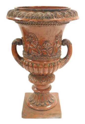 A late 19thC red stoneware campana urn, of semi fluted form, with leaf capped scrolling handles,...