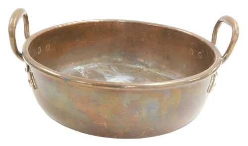 A late 19thC copper pan, with up and over handles, 35cm wide.