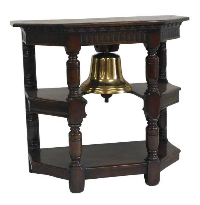 A metal ship's bell, mounted into an oak three tier side cabinet, with fluted frieze and turned...