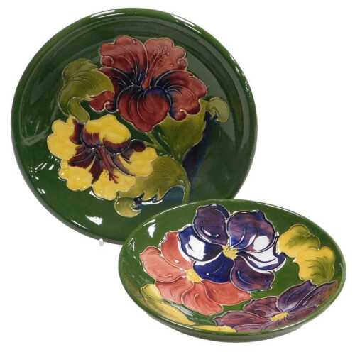 A Moorcroft pottery Hibiscus pattern plate, green ground, impressed and painted marks, 21cm wide,...