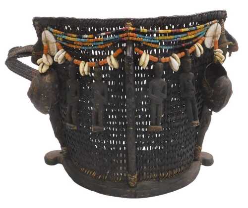 A Dayak rattan baby carrier, decorated with beadwork, shells, and carved wooden figures, 32cm high.