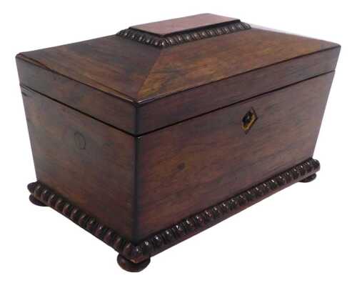A Regency rosewood sarcophagus form tea caddy, the hinged lid opening to reveal a twin lidded...