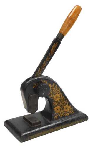 An early 20thC cast iron paper seal embosser, with a gilt floral decoration, 30.5cm wide.