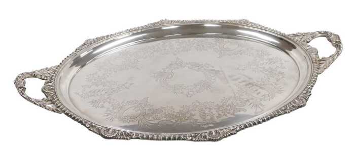 An Edward VII silver oval twin handled tray, with engraved Rococo style decoration of flowers...
