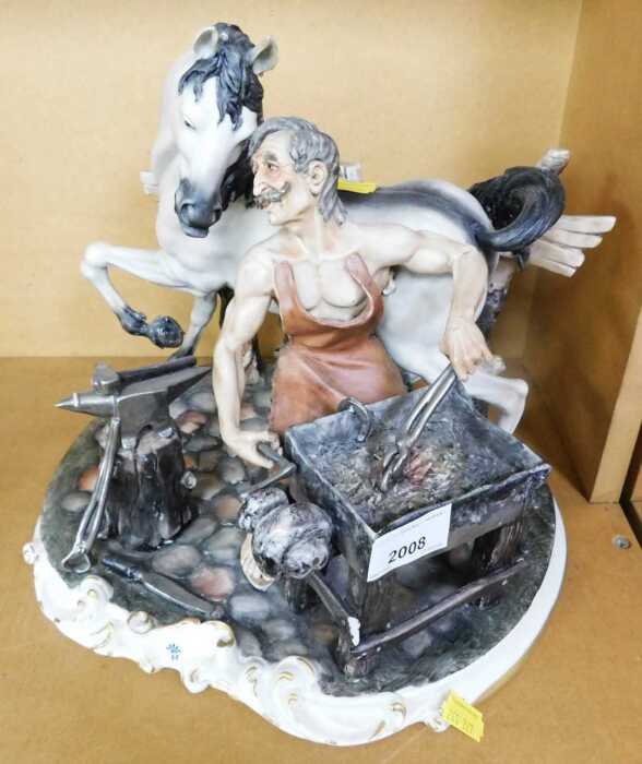 A Capodimonte ornament depicting a farrier with a horse, signed M. Tozy.