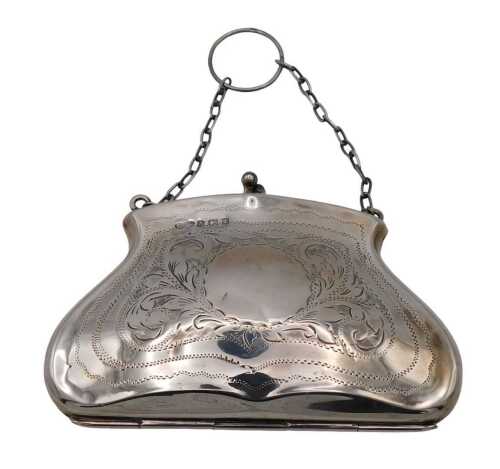 A George V silver evening bag, with a tan leather interior, with engraved foliate decoration,...