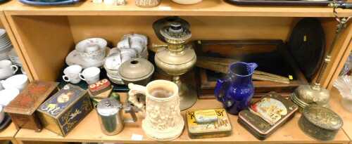 An oak framed table top display cabinet, various brass oil lamp bases, bygones tins, part tea...