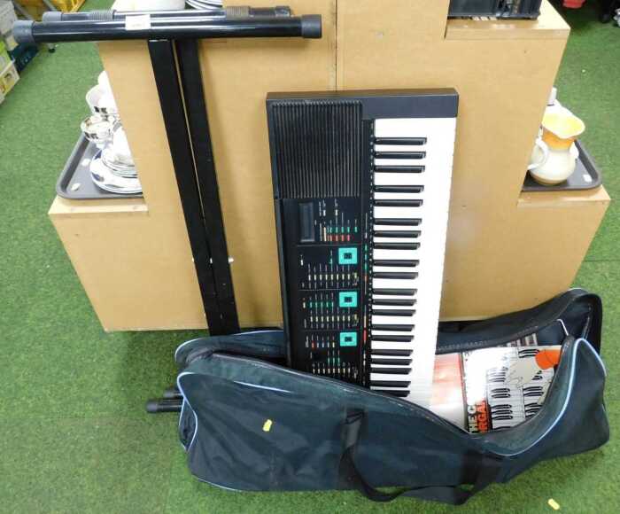 A Yamaha electric keyboard, PSR-90, on stand.