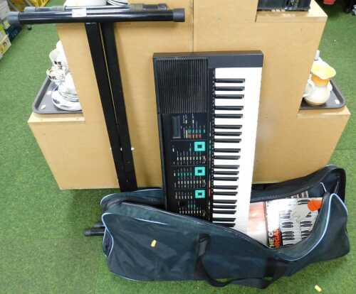 A Yamaha electric keyboard, PSR-90, on stand.