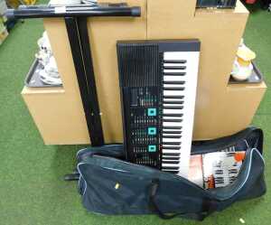 A Yamaha electric keyboard, PSR-90, on stand.