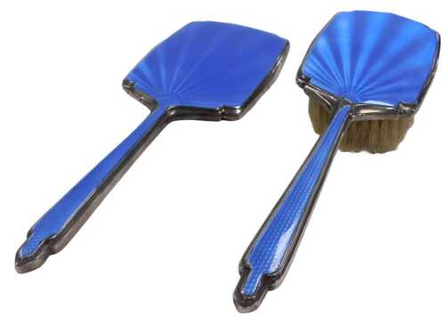 A George V silver and blue guilloche enamel backed hand mirror, and clothes brush, Birmingham 1934.