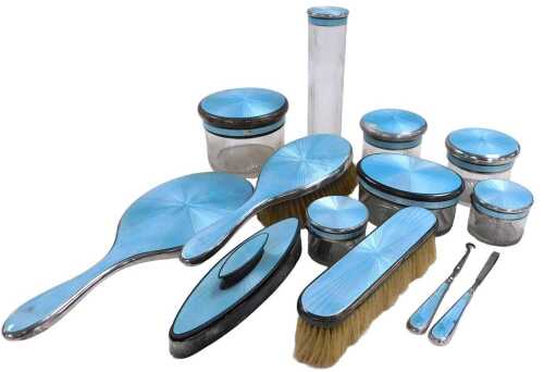 A George V cut glass silver and turquoise guilloche enamel mounted dressing table set,...