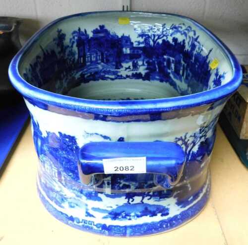 An ironstone twin handled blue and white footbath.