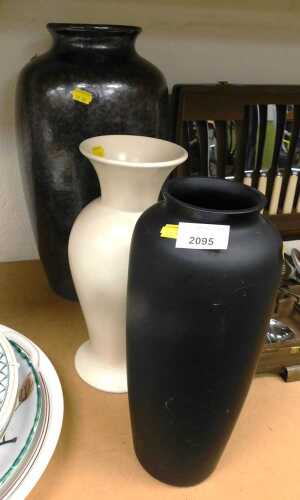 Three ceramic vases, comprising a black glazed example, cream glaze, and another with a lustre...
