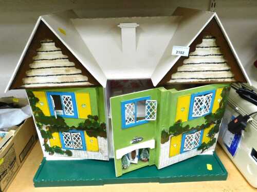 A Tudor Lodge doll's house, together with furniture, etc., the doll's house 62cm wide.