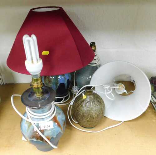 Two terracotta table lamps, with drop glaze decoration, together with two further lamps, two...