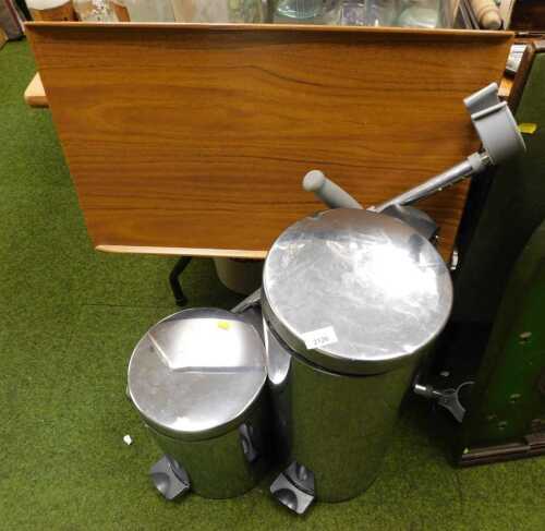 Two metal pedal pins, crutches, and an invalid table.
