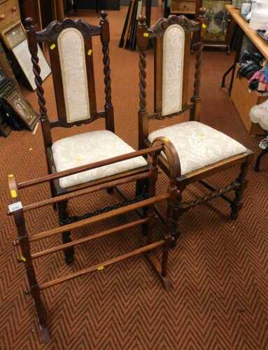 An oak towel rack, 73cm high, together with two oak chairs with barley twist detail.