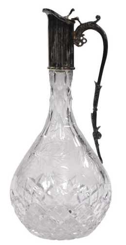An Elizabeth II cut glass claret jug, with silver mount, scrolling handle and hinged lid,...