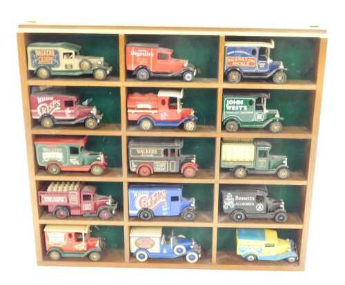 Fifteen Lledo and Matchbox diecast vintage trucks, unboxed, in a wooden display frame.