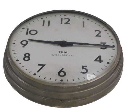 A late 20thC IBM International electric wall clock, circular dial bearing Arabic numerals, in a...