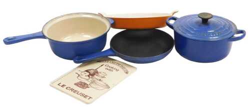 A Le Creuset blue enamel casserole dish and cover, number 18, a saucepan, number 22, small...