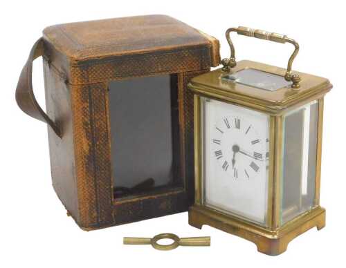 An early 20thC French brass cased carriage clock, the rectangular enamel dial bearing Roman...