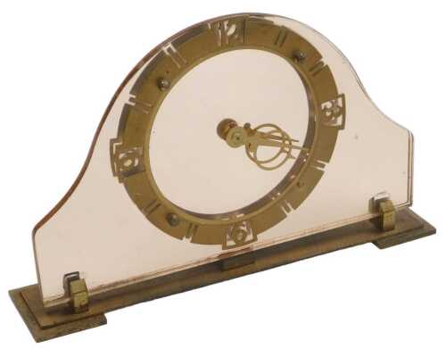 An Art Deco pink glass and brass mantel clock, with a brass circular chapter ring bearing Arabic...