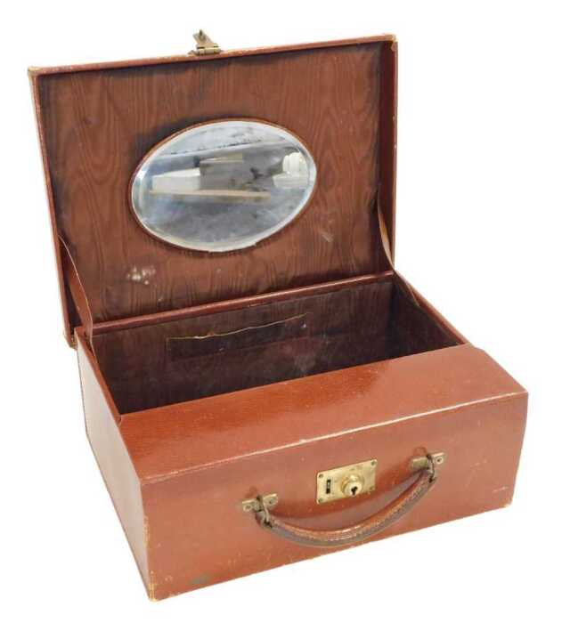 An early 20thC Cartier tan leather vanity case, gilt monogram stamped, with a brown watered silk...