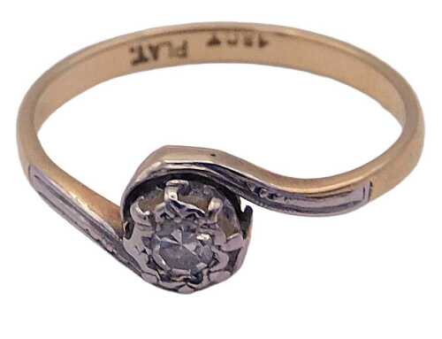 A diamond solitaire ring, in a crossover setting, in yellow and white metal, stamped 18ct and...