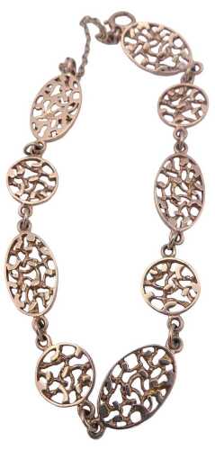 An oval and circular fancy link bracelet, in an openwork abstract design, on a bolt ring clasp,...