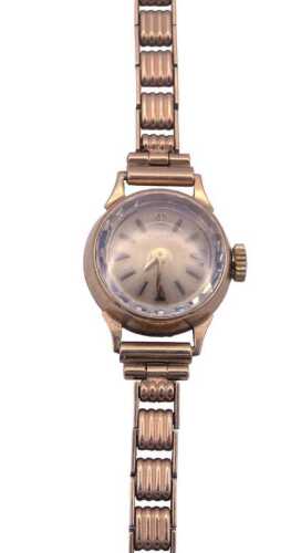 A Tissot lady's 9ct gold cased wristwatch, the circular champagne dial with baton markers,...