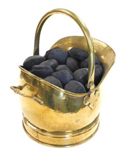 A Victorian brass helmet shaped coal scuttle, containing coal, 33cm wide.