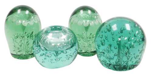 Two Victorian green glass dumps, each set with a single flower and air bubble leaves, 11cm high,...