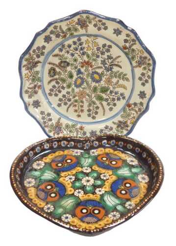 A Thoune plate, decorated all over with flowers on a cream ground, 21cm wide, and a heart shaped...