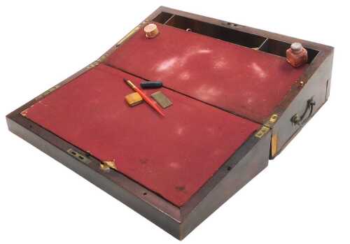 A Victorian mahogany writing box, the hinged lid opening to reveal a red baize slope, and a...