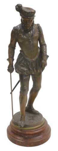 A late 19thC French spelter figure of a sixteenth-century gentleman, raised on a faux red marble...