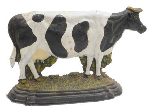 A painted cast iron doorstop, modelled as a cow, 36cm wide.