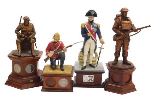Four Danbury Mint commemorative figural coin holders, comprising The Defender, World War II 1939,...