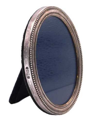 An Elizabeth II silver backed strut photograph frame, with a beaded rim, Robert Carr, Sheffield...