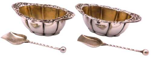 A pair of Edward VII silver salts, of fluted form, with a floral and foliate embossed rim,...